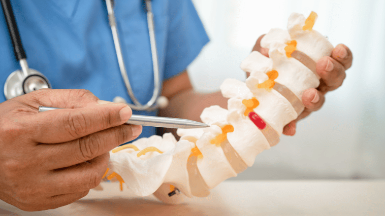 Chiropractor Examining Slipped Disc Patient