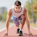 Image of a focused athlete in a starting position on a track, highlighting Thai massage benefits, including improved athletic performance, enhanced flexibility, and quicker muscle recovery.