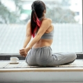 Image of a woman stretching in a serene environment, highlighting Thai massage benefits, including increased flexibility and improved range of motion for enhanced physical well-being.