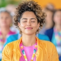 Image of a relaxed woman smiling with her eyes closed, highlighting Thai massage benefits, including improved mental clarity, stress reduction, and relief from confusion for enhanced focus and well-being.